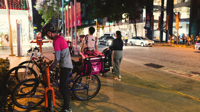 Taguig, Philippines - November 25, 2018: a delivery boy using his bike for work on a busy night