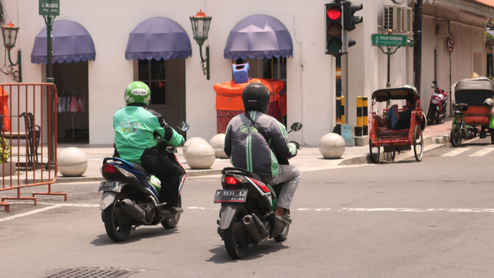 Two Gojek workers on their motorbikes in Yogyakarta, Indonesia