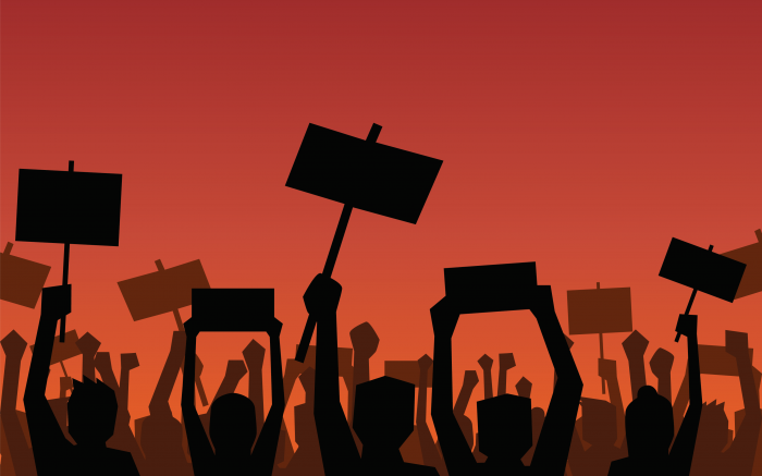 Silhouettes of protesting people