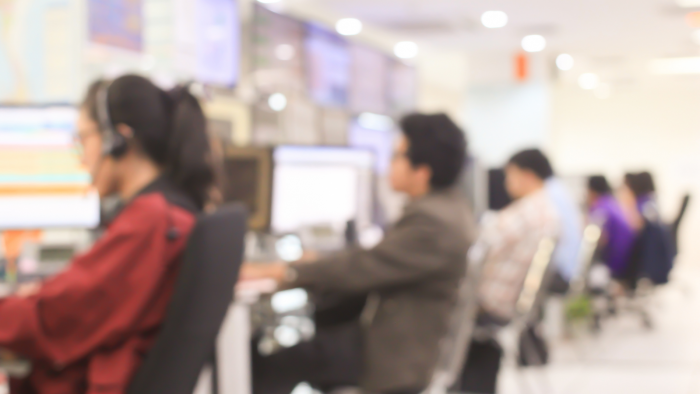 Blur employee work as call centre talking with customer at operation monitor room concept.
