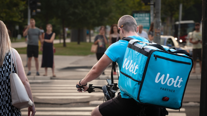 A Wolt courier navigating street in Belgrade, Serbia