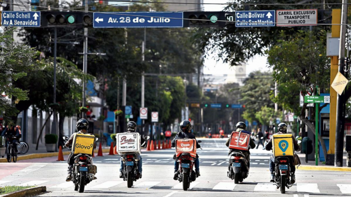 Platform workers riding on the street in Peru.